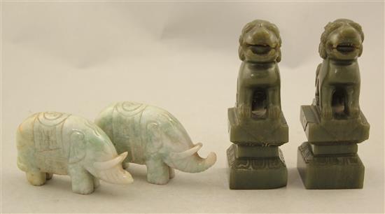 A pair of Chinese spinach green jade lion-dogs and a pair of jadeite figures of elephants, 20th century, 9.5cm, one wood stand